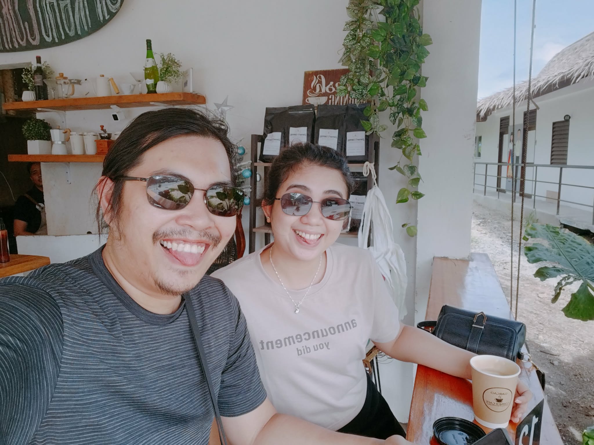 Gerald and Edin sticking tongues out at a Siargao cafe