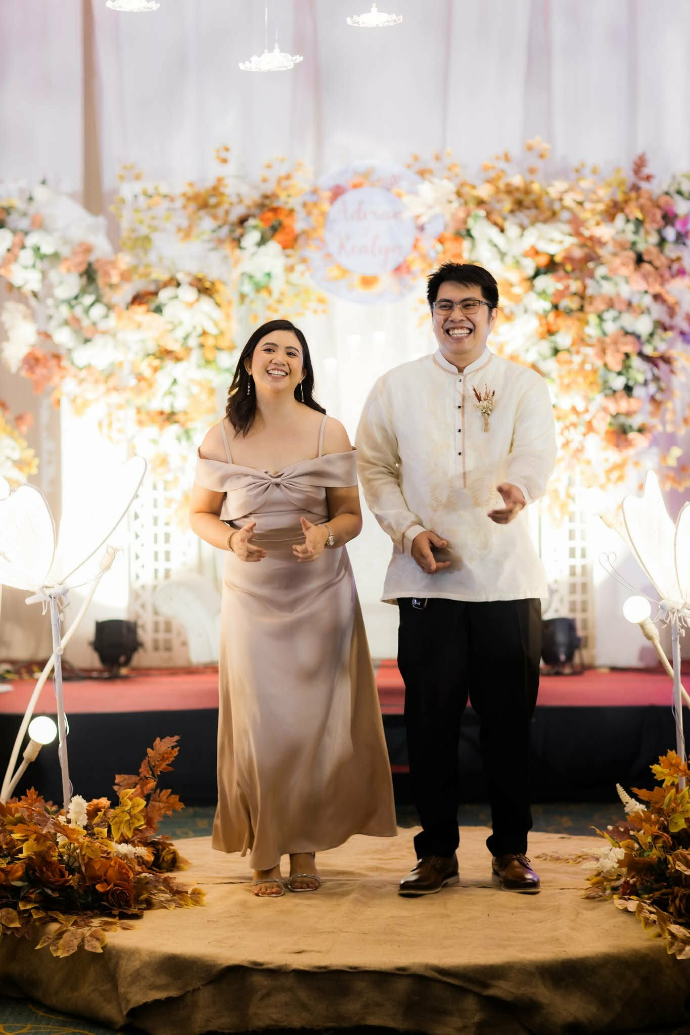 Gerald in a barong and Edin in a gown at a wedding reception